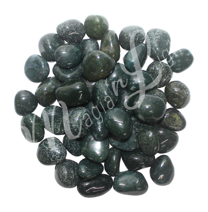 Collection of polished tumbled stones in shades of dark green and black with white specks, arranged together in a circular pile.