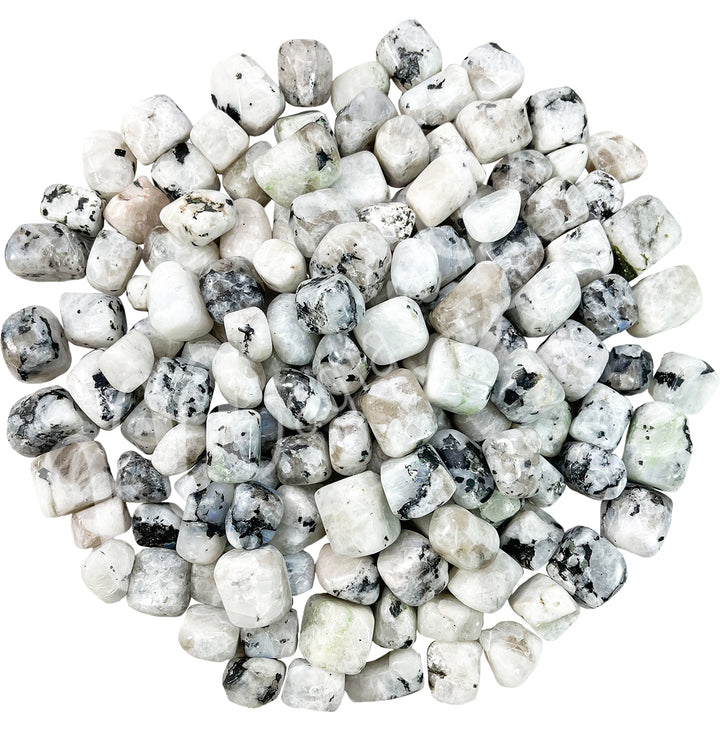 Collection of polished tumbled stones in shades of white and black, arranged together in a circular pile.