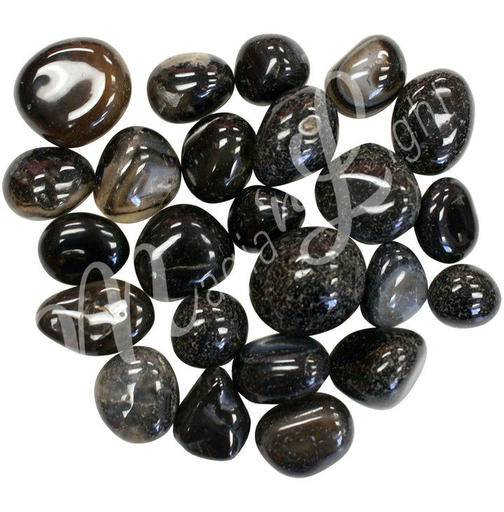 Collection of polished tumbled stones in shades of black, brown, and beige, arranged together in a circular pile.