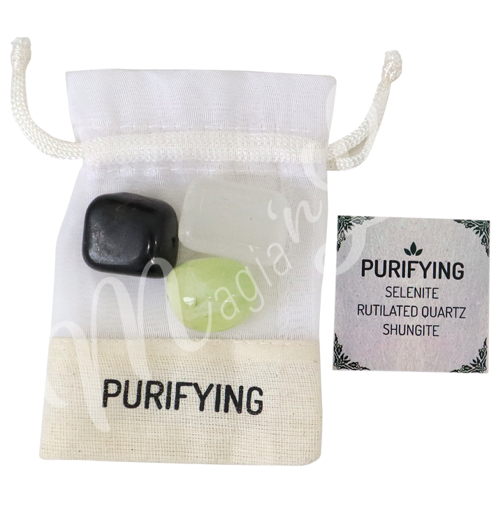 A white drawstring pouch labeled “PURIFYING,” displayed with three polished stones—Selenite, Rutilated Quartz, and Shungite—alongside a tag that reads “PURIFYING: Selenite, Rutilated Quartz, Shungite.”