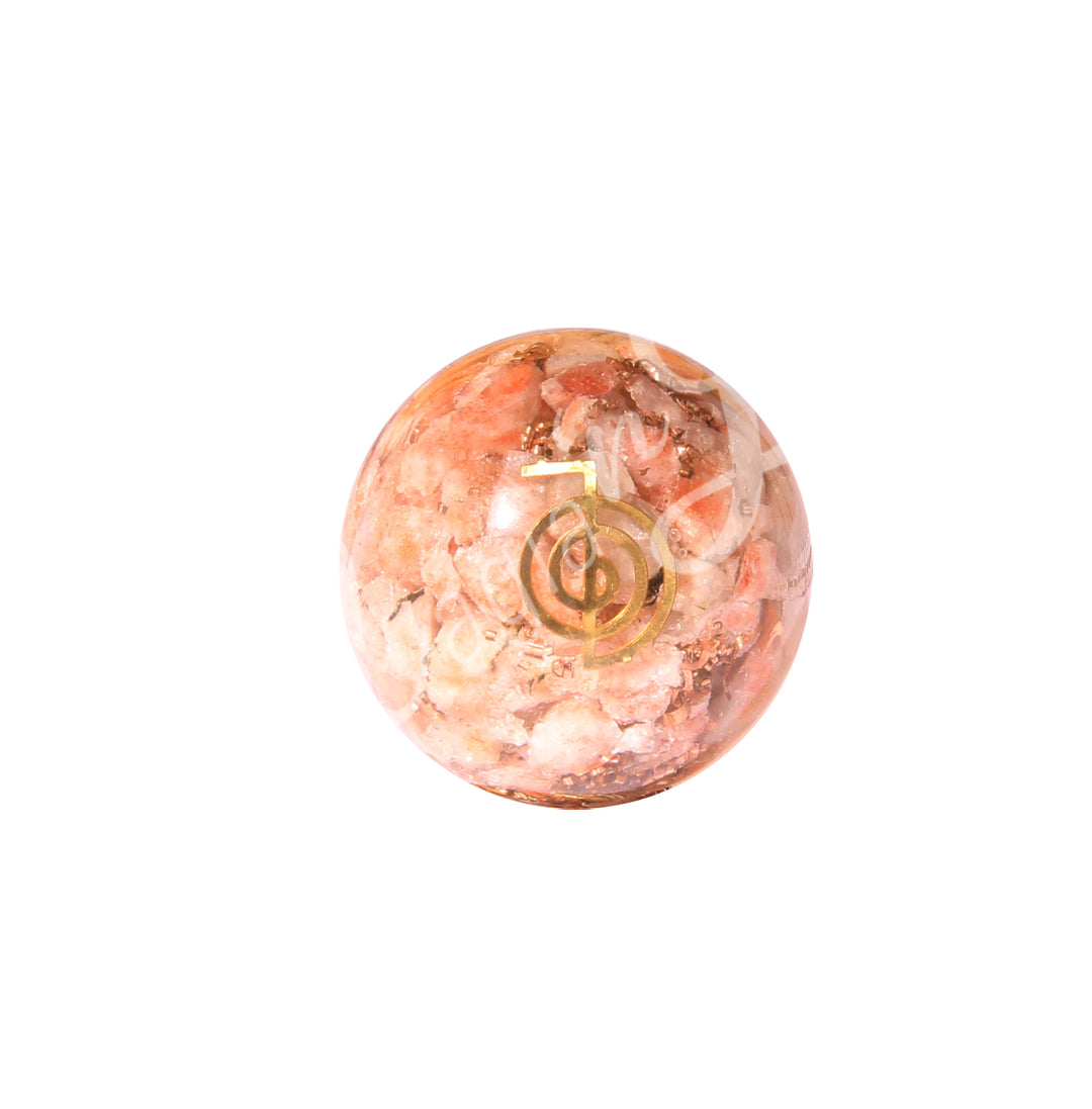 A sphere made of sunstone, featuring the Reiki symbol.