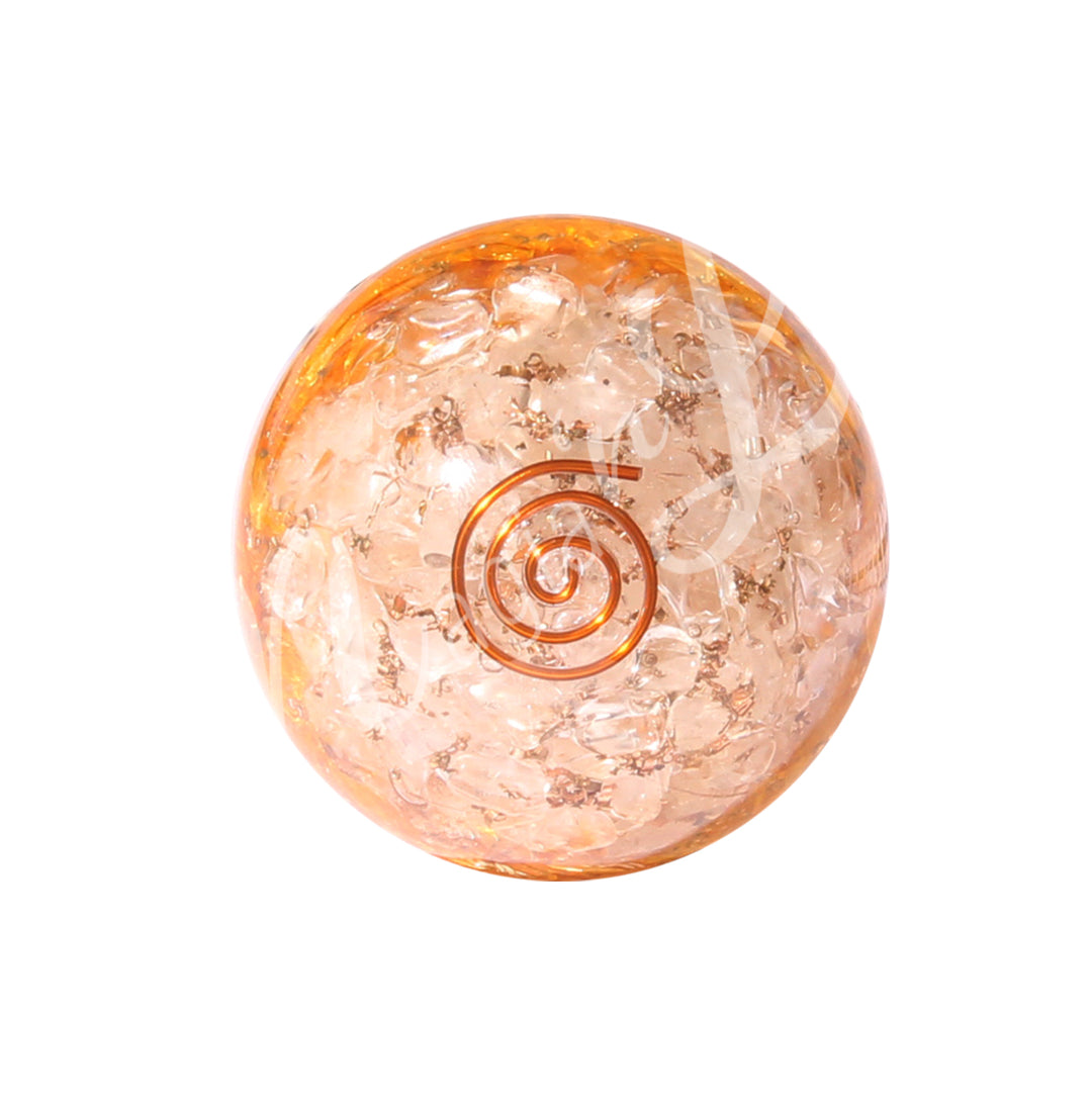 Gemstone chips in crystal quartz and citrine inside a clear sphere with a spiral made of copper wire.