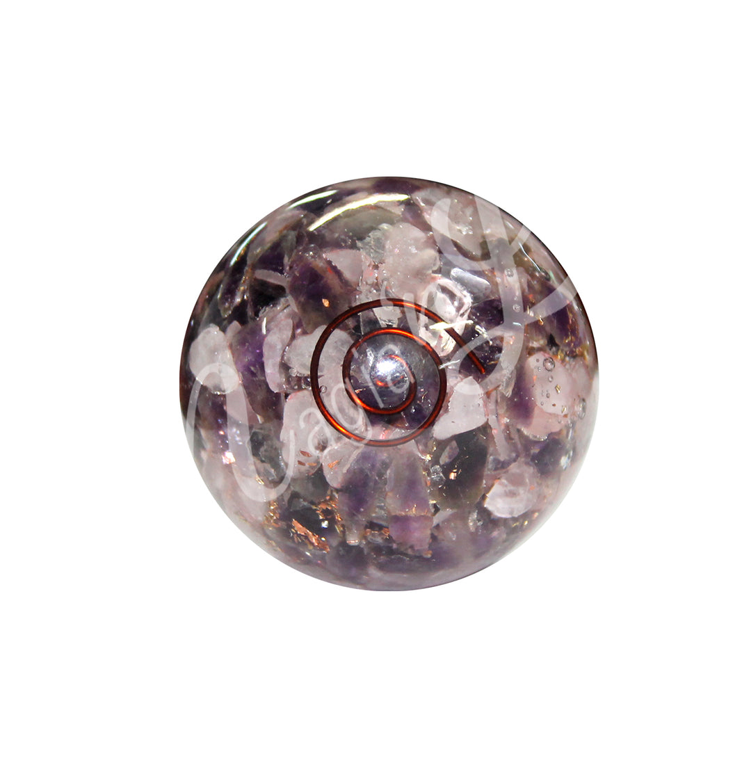 Gemstone chips in amethyst and rose quartz inside a clear sphere with a spiral made of copper wire.