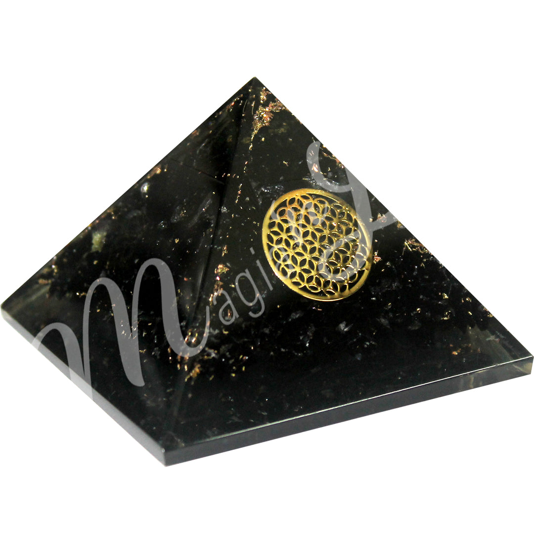 A four side pyramid made of Black Tourmaline in Orgone, featuring the flower of life symbol on one side.