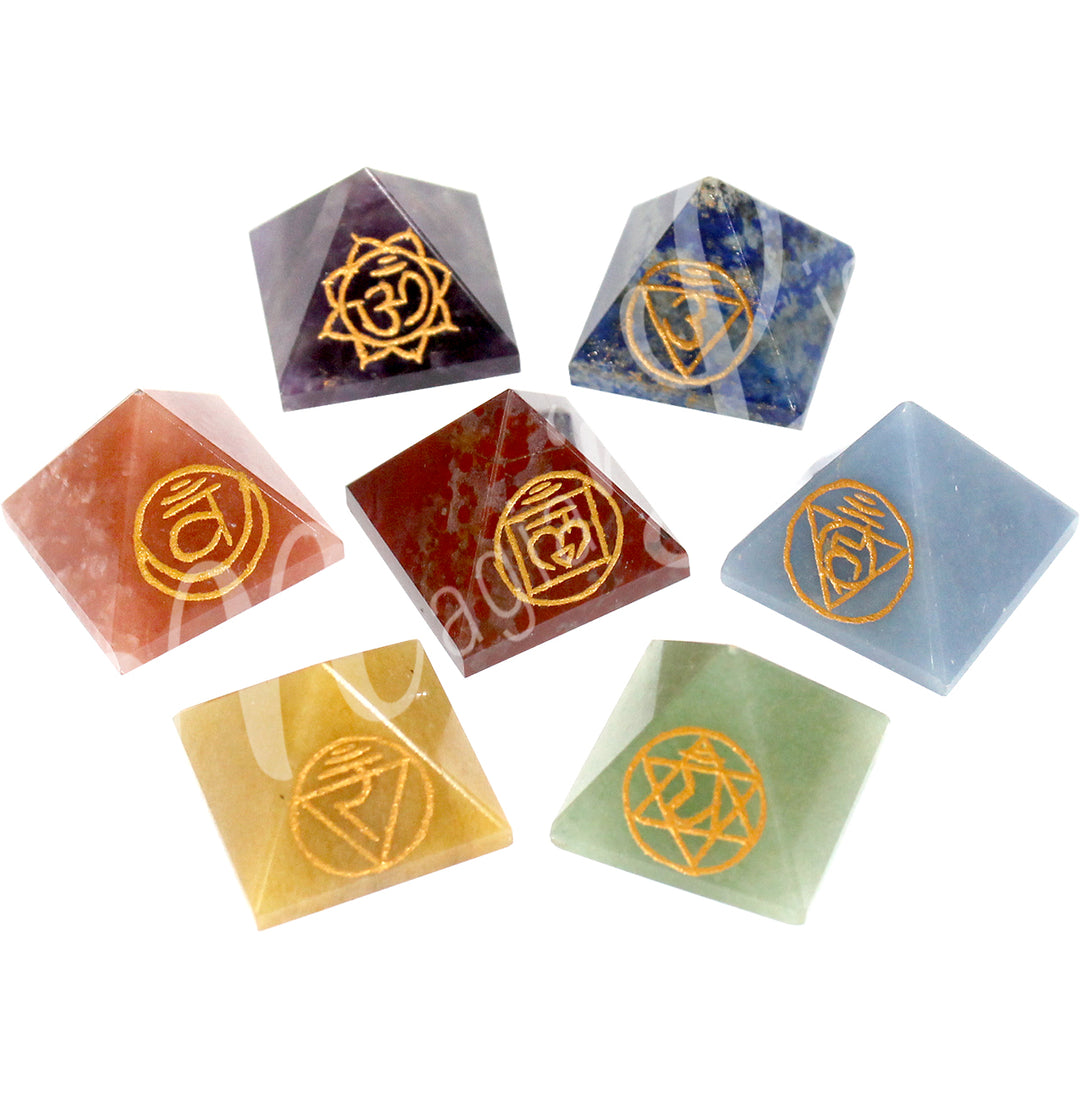 Seven four-sided pyramids, each made from a different stone and featuring its corresponding chakra symbol.