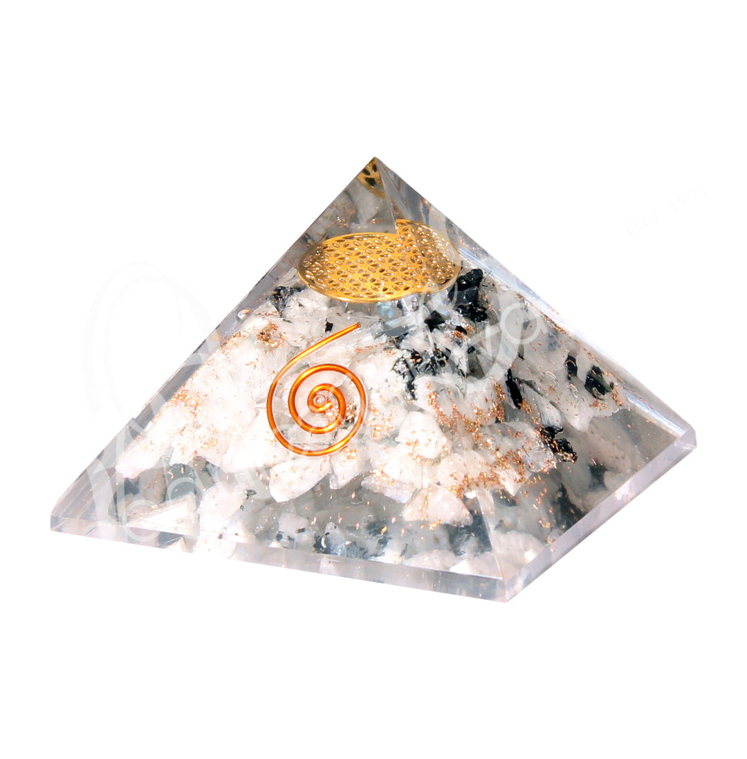 A four side pyramid made of Rainbow Moonstone in Orgone, featuring the flower of life symbol inside and a copper spiral on one side.