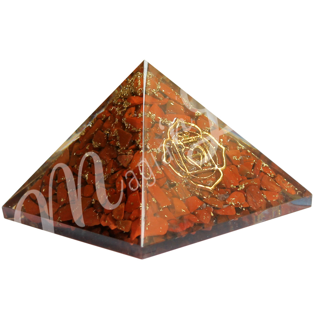 A four side pyramid made of Carnelian in Orgone, featuring the sacral chakra symbol on one side.