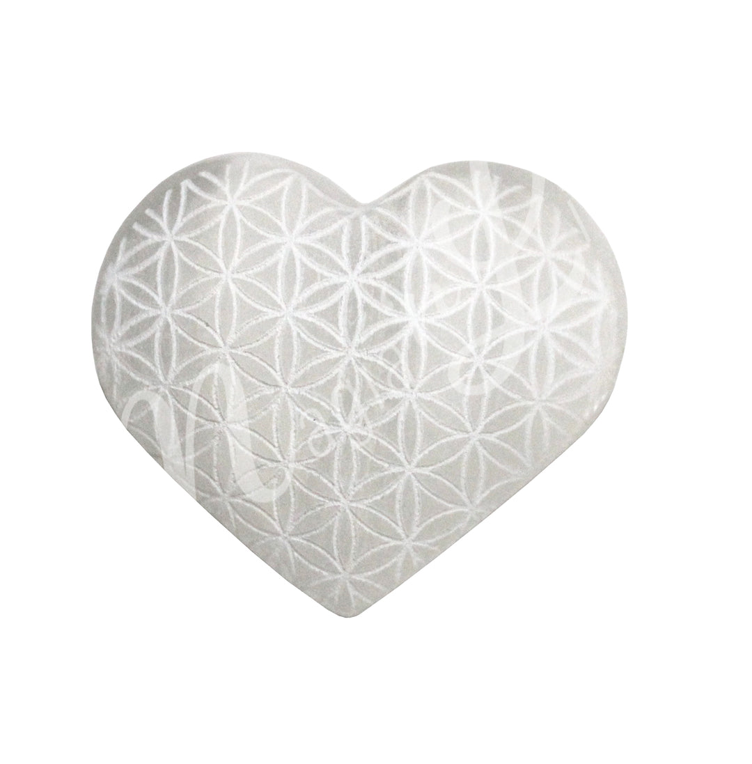 An heart-shaped Selenite crystal engraved with the flower of life symbol.