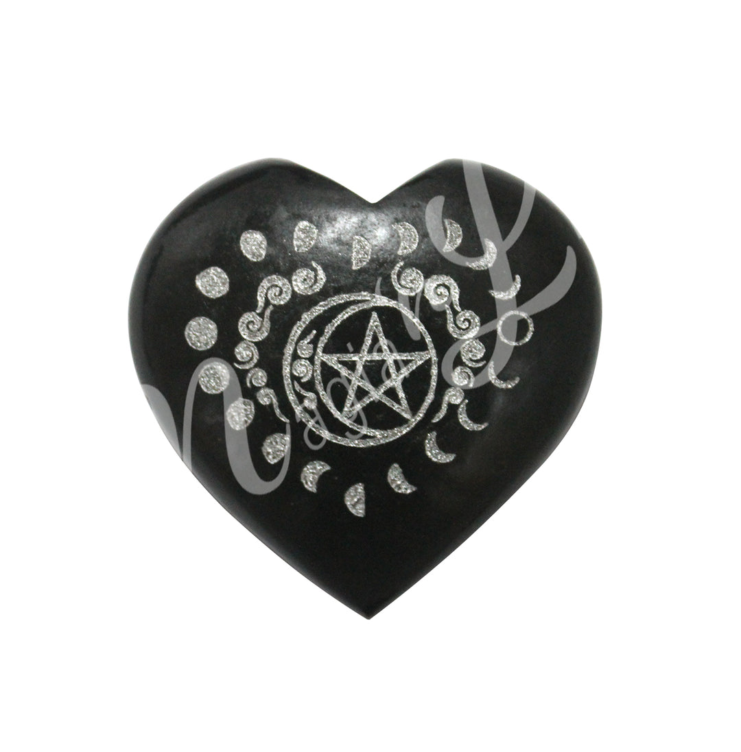 An heart-shaped black tourmaline crystal engraved with the lunar cycle and a pentacle.