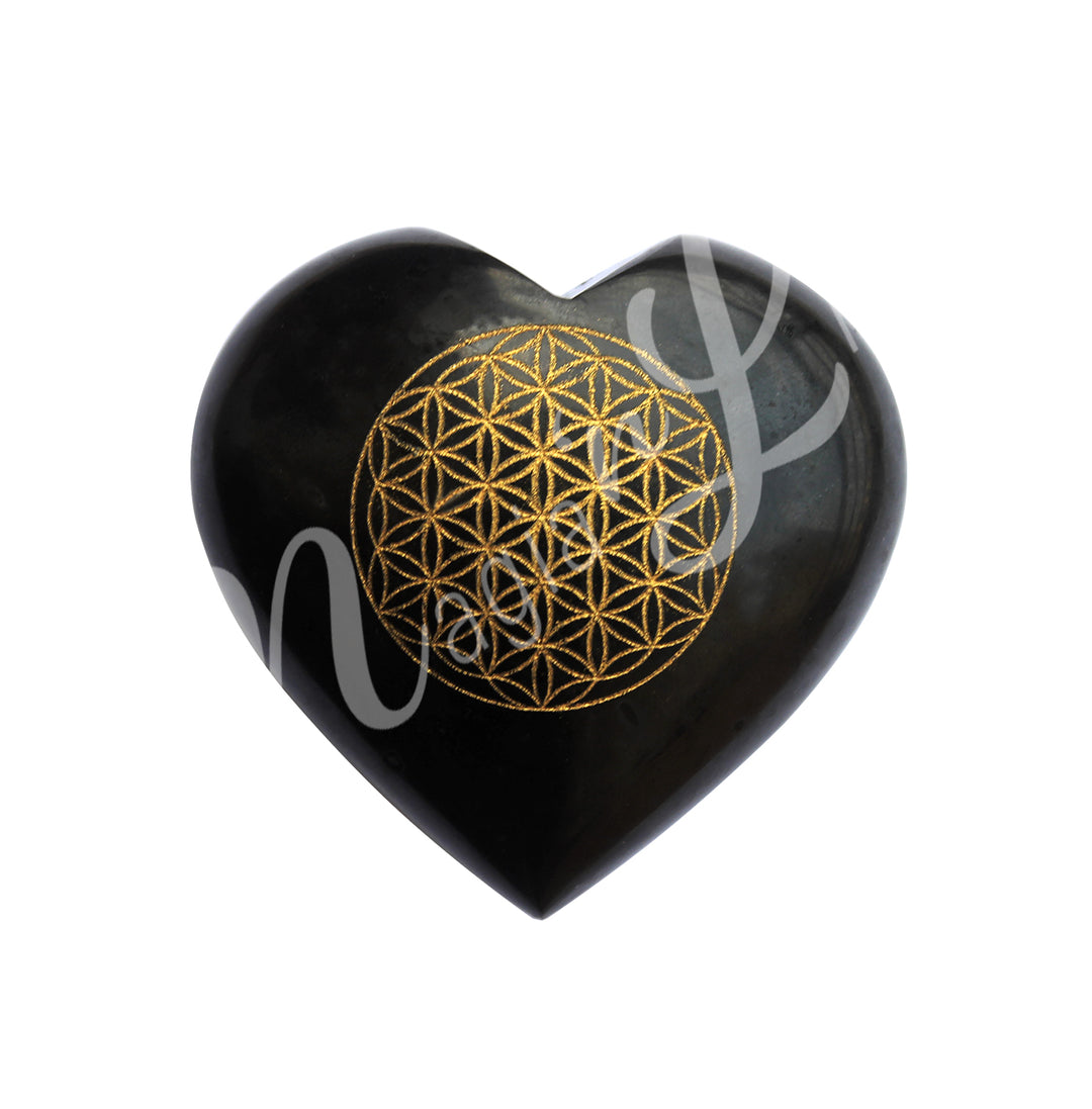 An heart-shaped black tourmaline crystal engraved with the flower of life symbol in gold color.