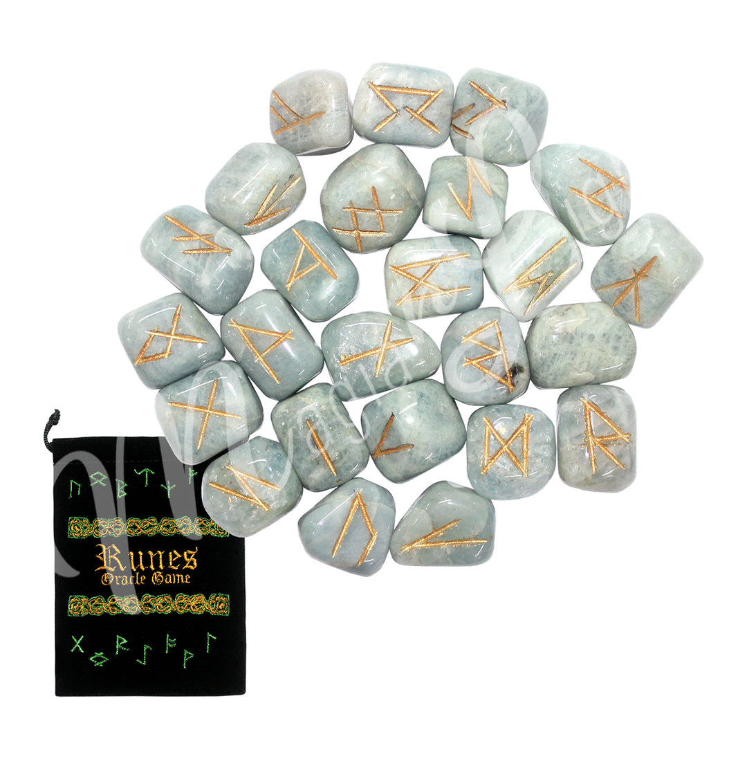 A set of aquamarine runestones with engraved and painted gold symbols, displayed with a black velvet pouch. The pouch is embroidered with the words "runes oracle game", as well as runic symbols.