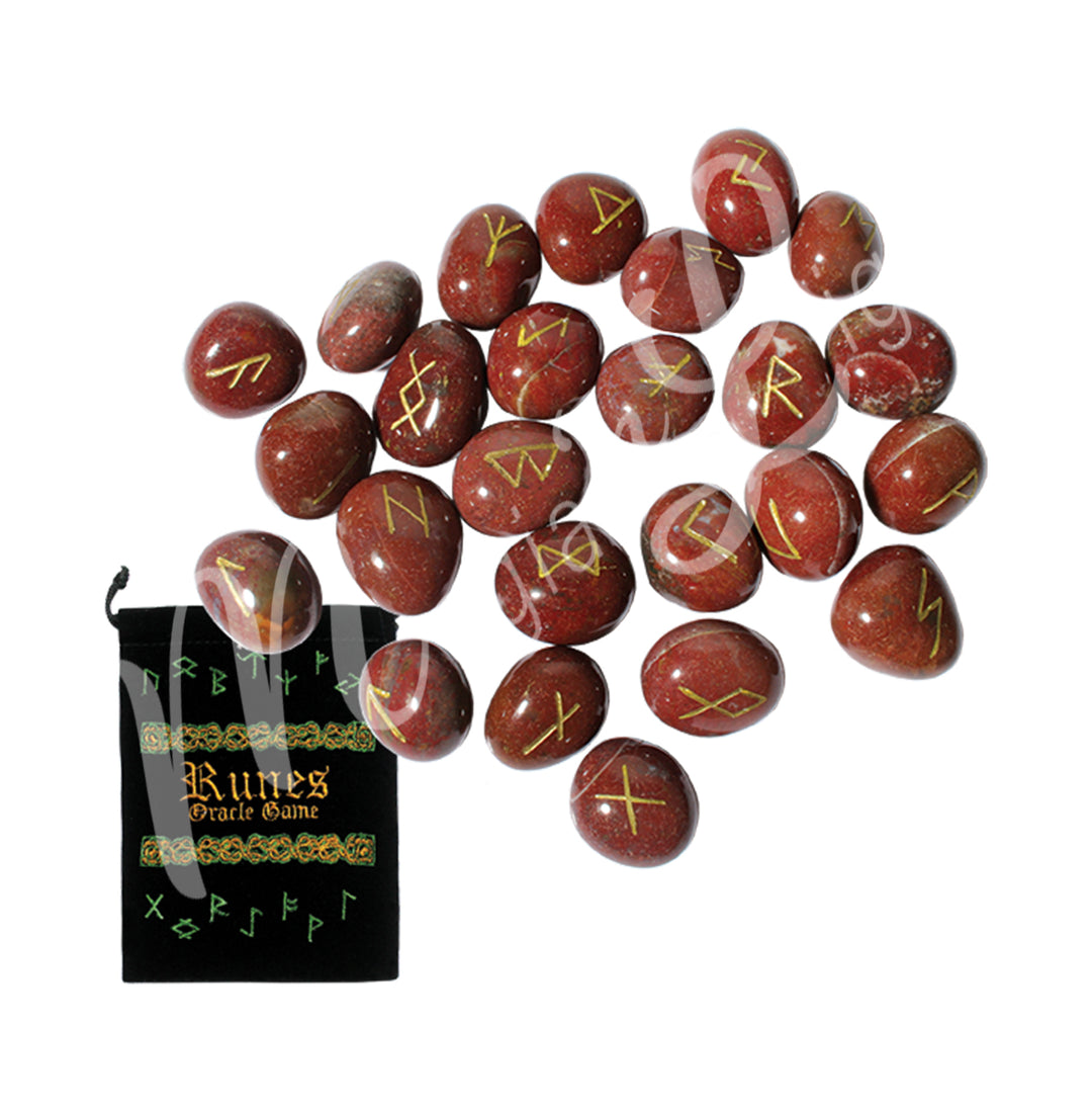 A set of red jasper runestones with engraved and painted gold symbols, displayed with a black velvet pouch. The pouch is embroidered with the words "runes oracle game", as well as runic symbols.