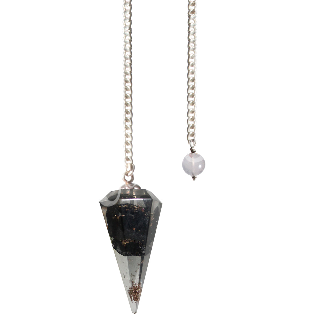 An hexagonal shaped shungite in orgone pendulum with a silver chain.