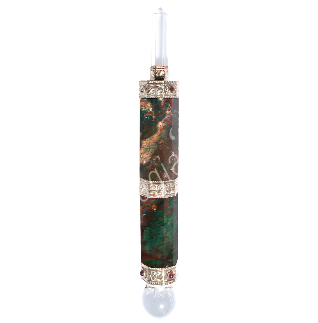 A Bloodstone wand with a crystal quartz point on one end and a sphere on the other. Metal caps on both ends, featuring carved patterns along the shaft.