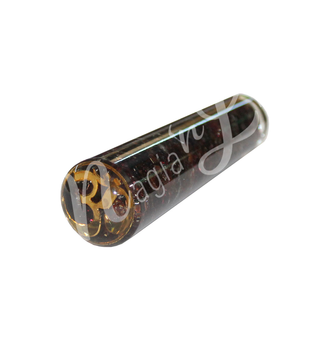 Polished garnet in orgone massager with OM design, ideal for reflexology, acupressure, or crystal healing therapy.