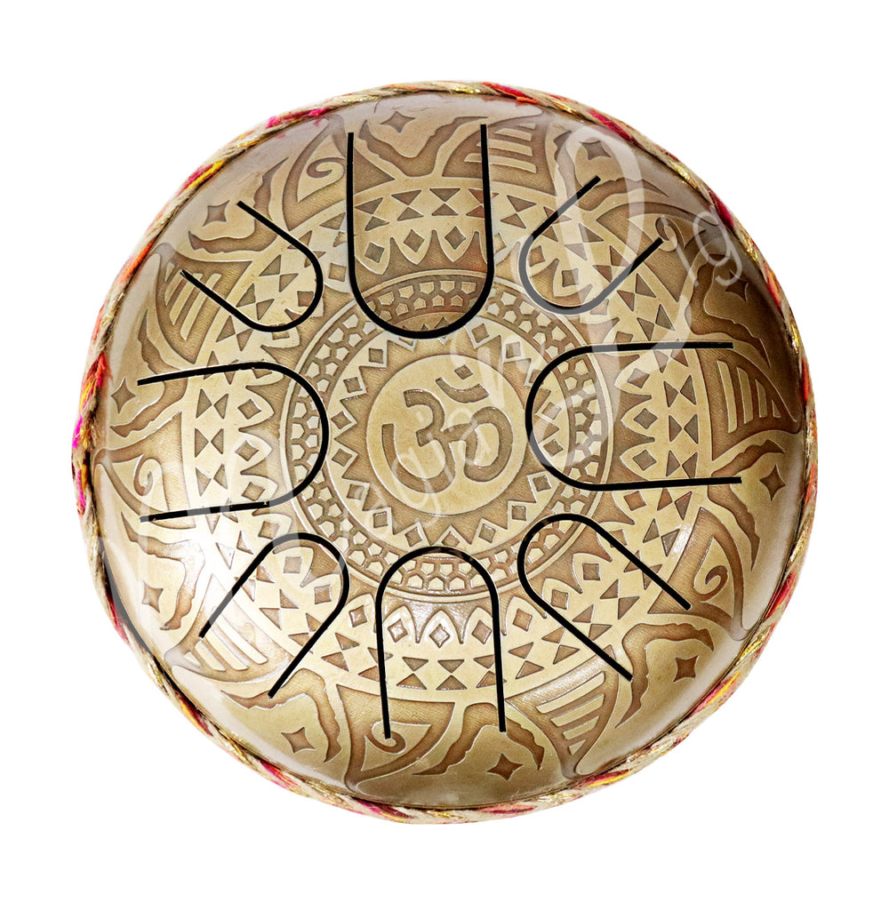 A top view of an iron tongue drum with a speckled finish, featuring multiple U-shaped cutout tongues and an OM design.