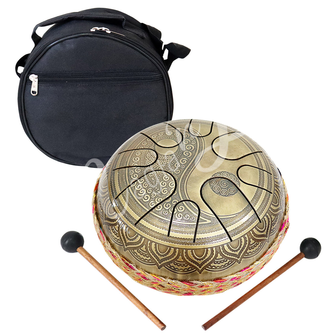 An iron tongue drum with a yin yang design, accompanied by two wooden mallets with black rubber heads and a round black carrying case.