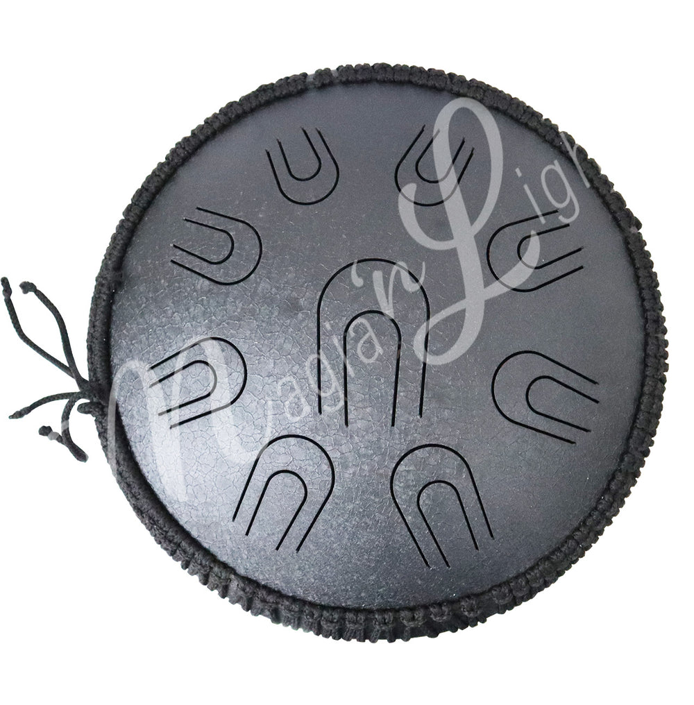 A top view of a black iron tongue drum with a speckled finish, featuring multiple U-shaped cutout tongues.