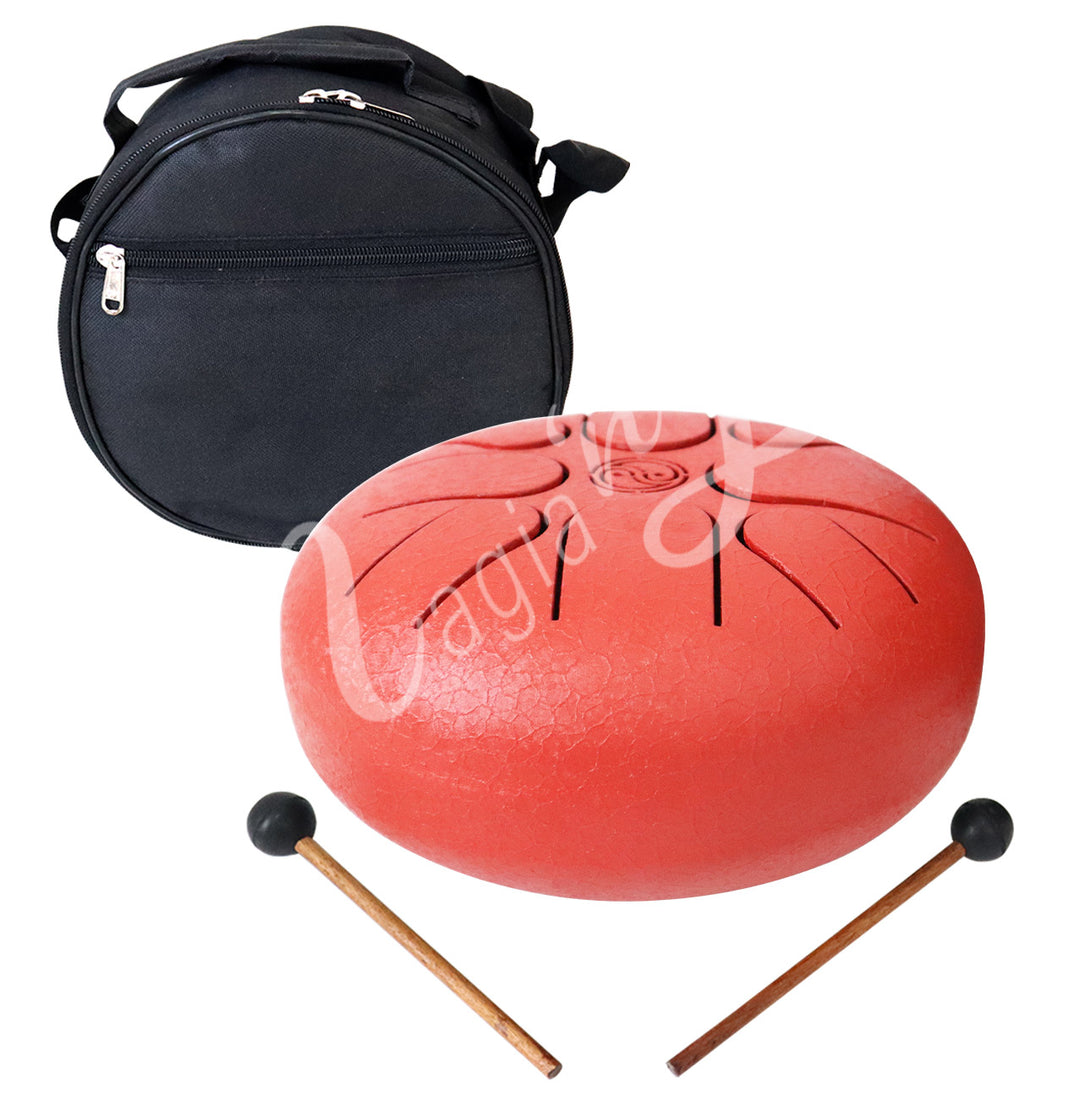 A red iron tongue drum, accompanied by two wooden mallets with black rubber heads and a round black carrying case.