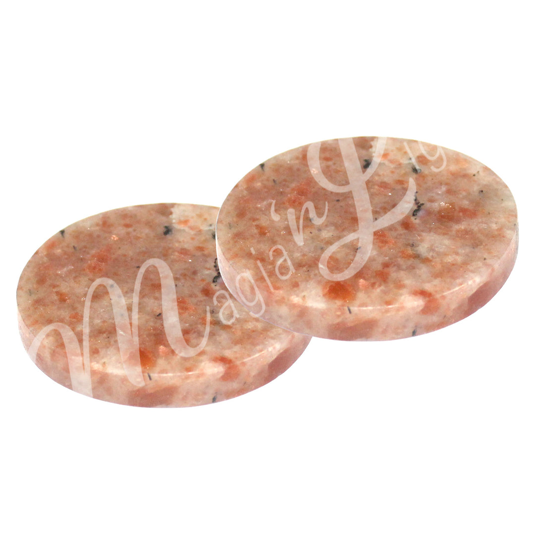 Two round sunstone coasters.