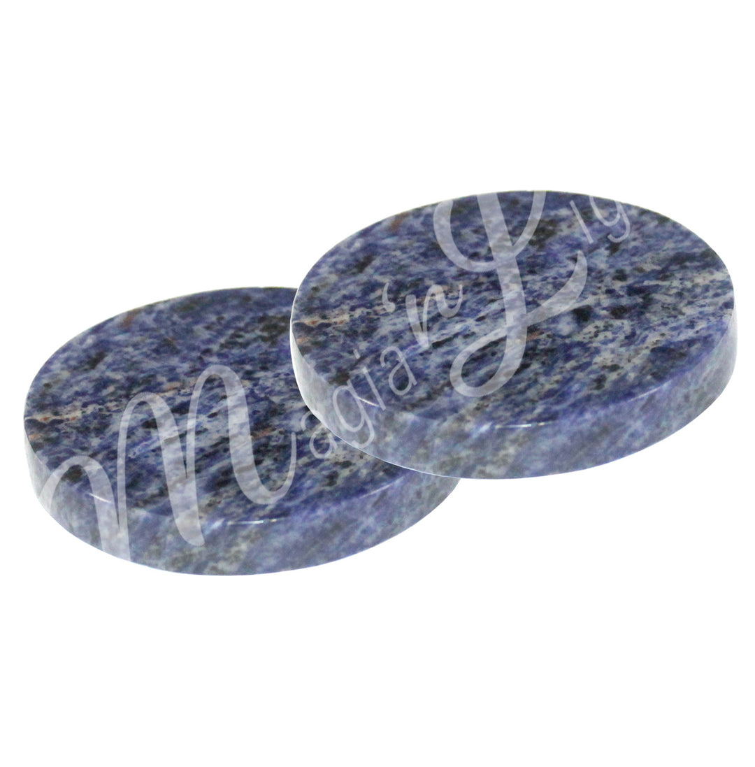 Two round sodalite coasters .