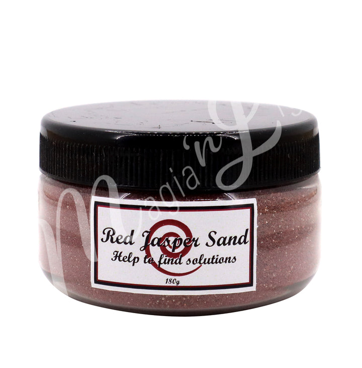 Clear plastic jar with a black lid containing red stone sand. The label reads “Red Jasper Sand – Help to find solutions, 180 g.”