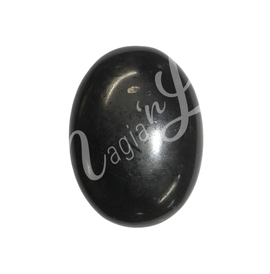 Close-up of a polished oval palm stone made of Black Tourmaline.