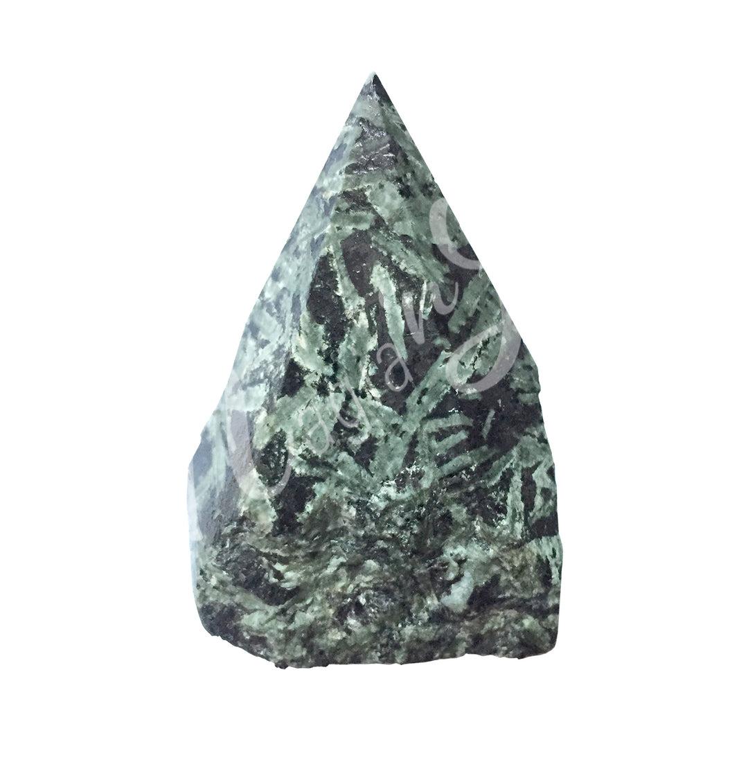 A piece of black and green stone. The top is cut to form a point.