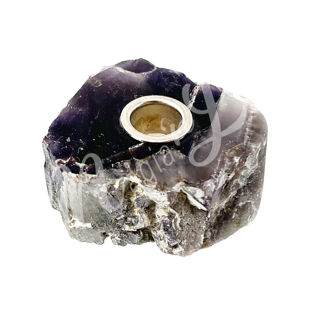A natural amethyst tealight candle holder with metal insert.