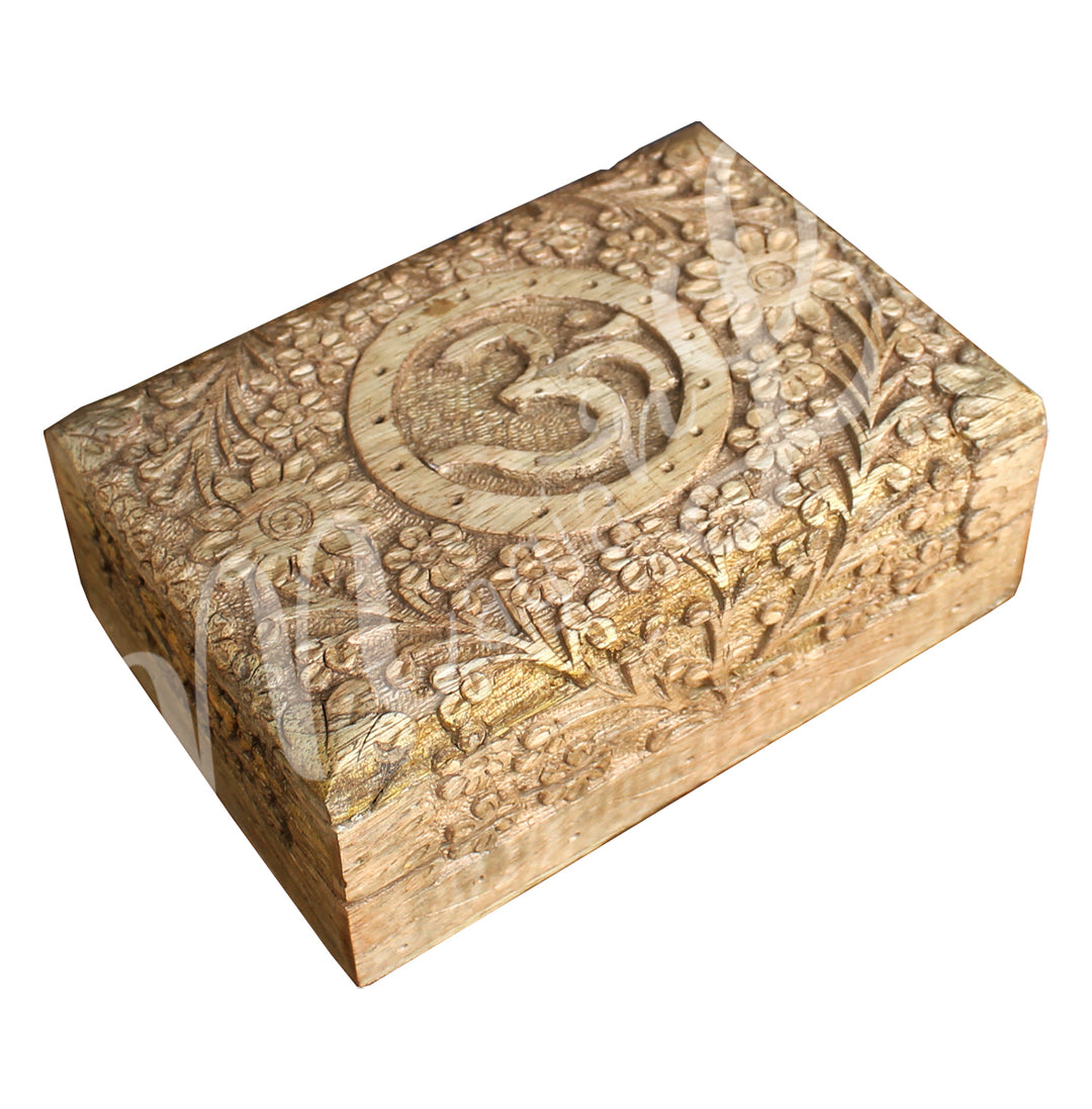 A wooden box features a carved OM symbol at the center, surrounded by many flowers.