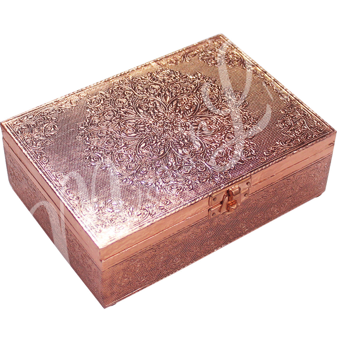 A copper-plated box features a mandala design on the lid.