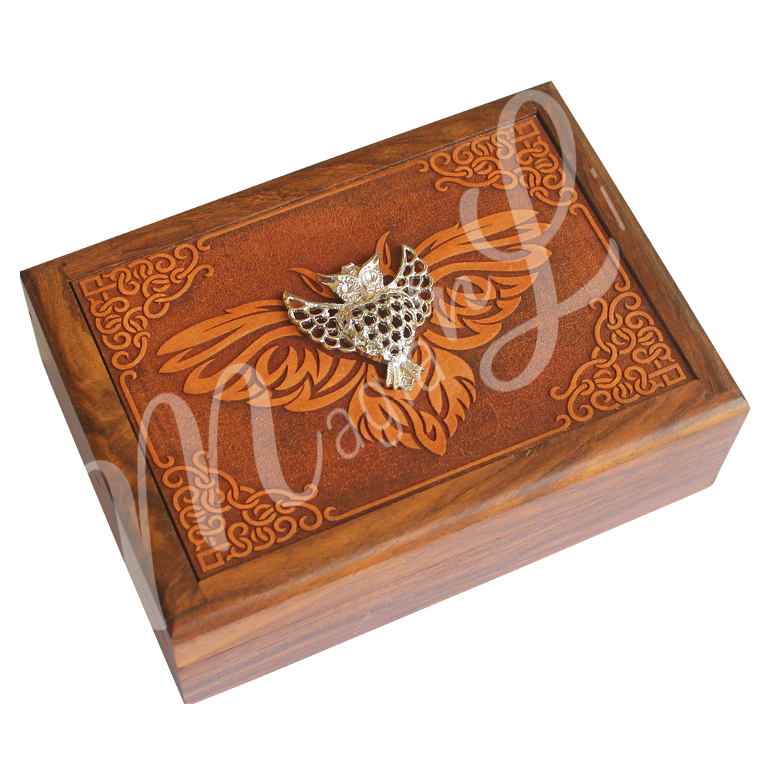A wooden box features an owl design on the lid, with a metal owl charm affixed on top.