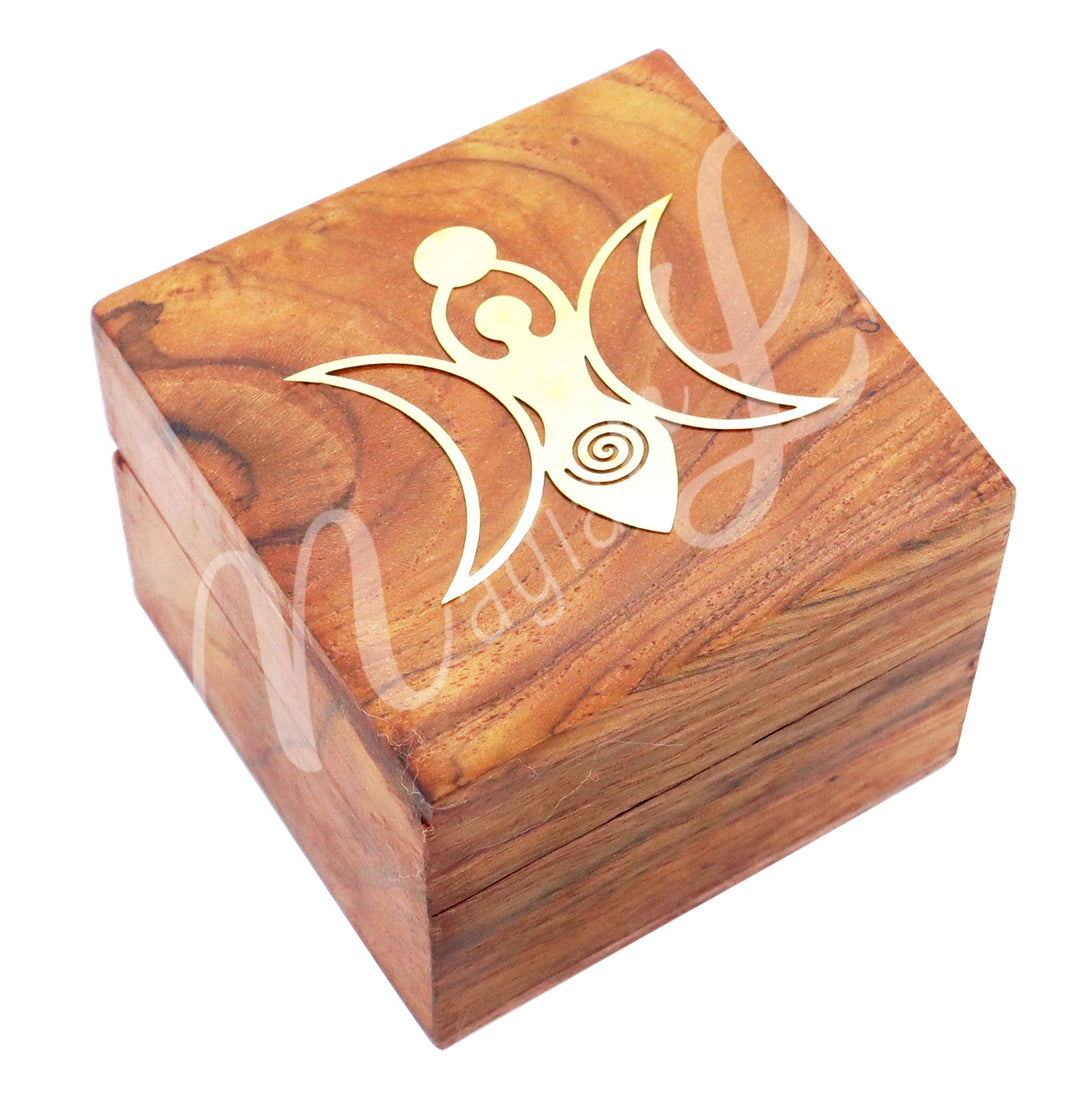A box made of acacia wood. The lid is adorned with a brass moon goddess symbol.