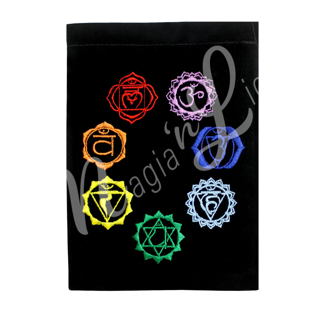 A black velvet bag featuring an embroidery of the seven chakra symbols, each in its respective color.