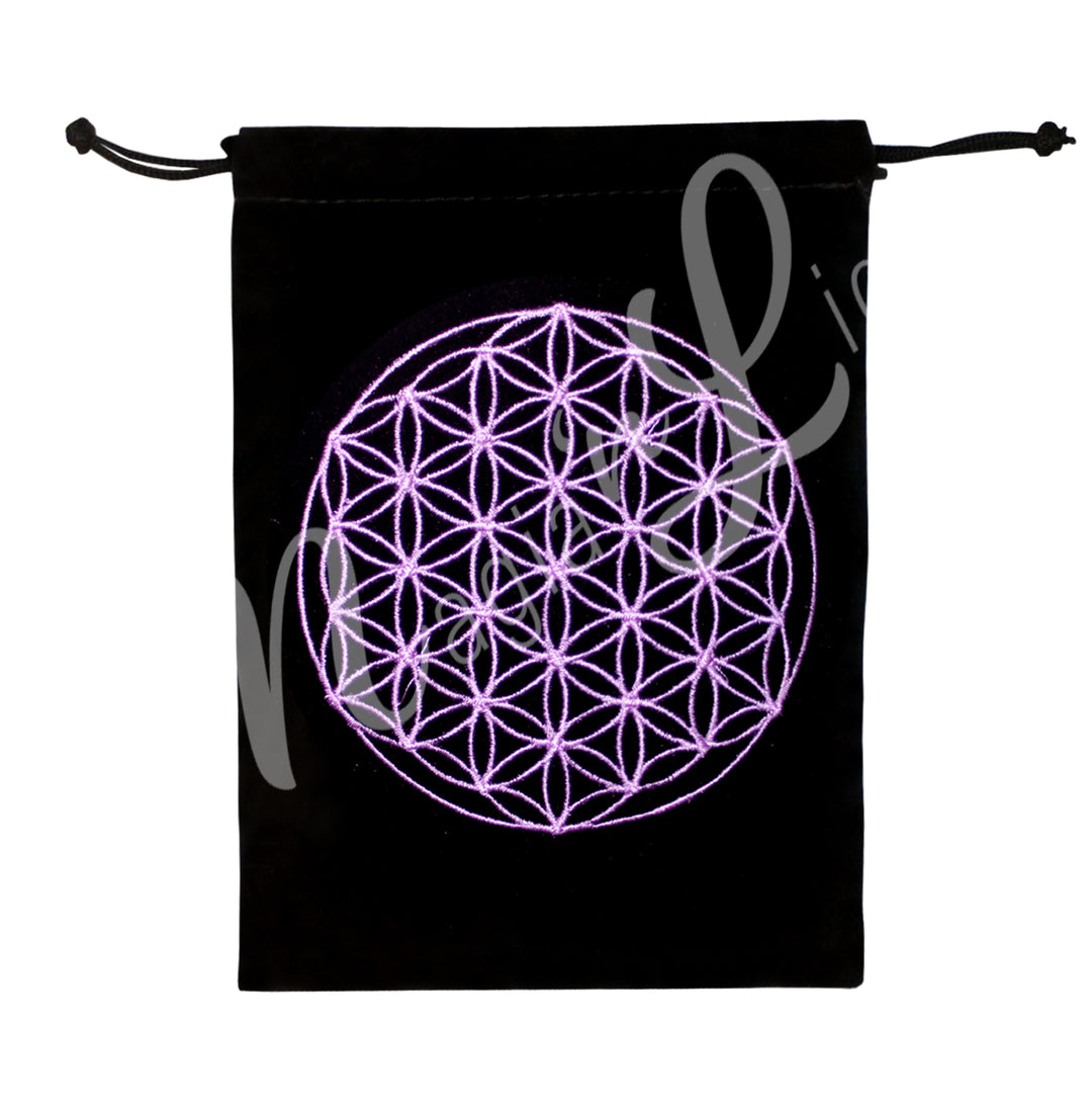A black velvet bag with drawstrings featuring a pink Flower of Life design embroidery.