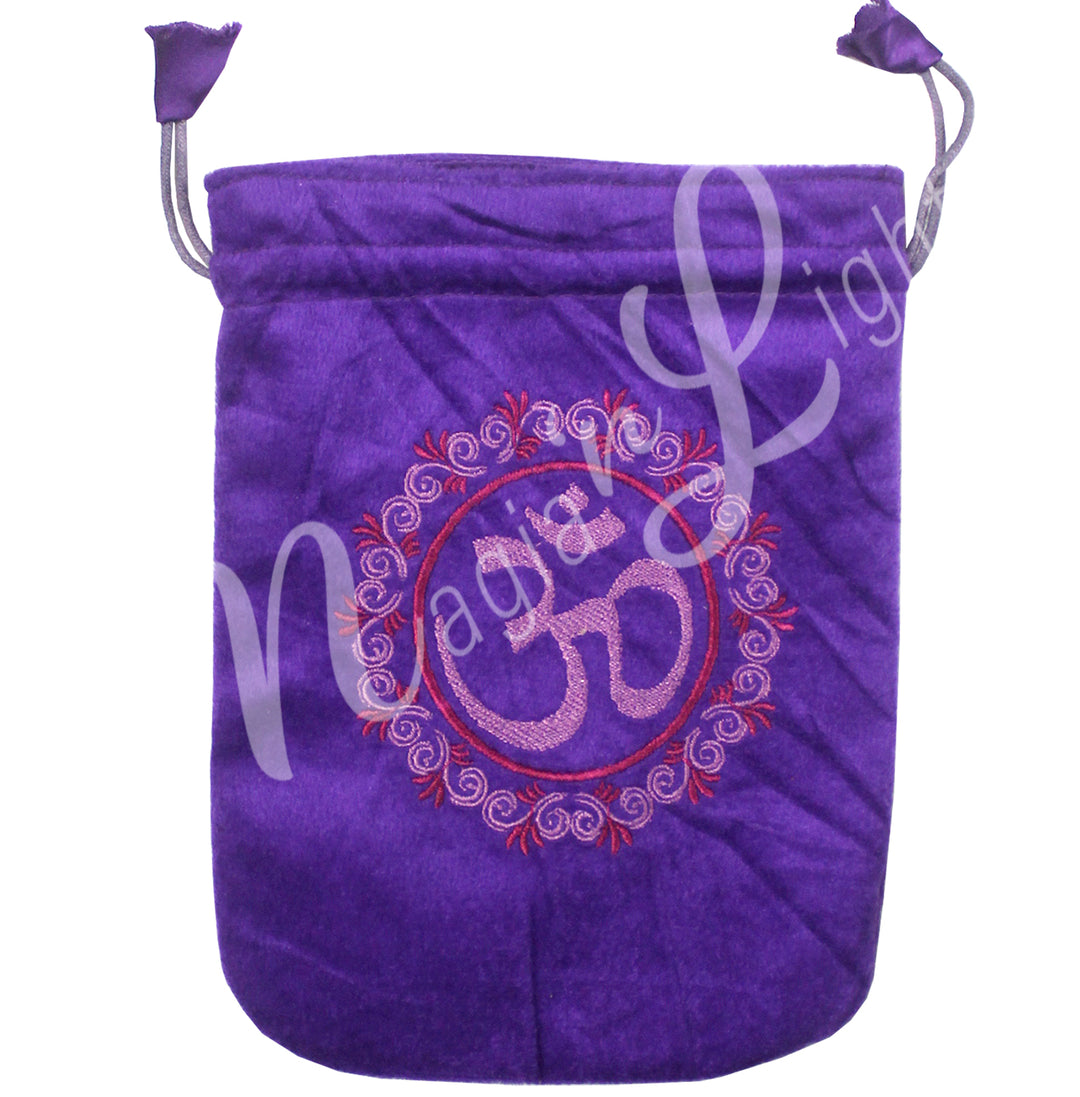 A purple velvet bag featuring an embroidered of the OM symbol surround by a decorative circle.