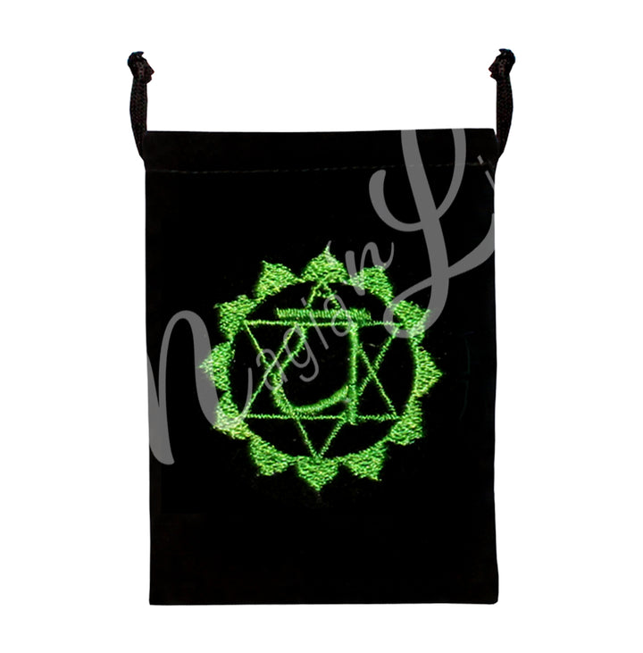 A black bag featuring an embroidered heart chakra green design