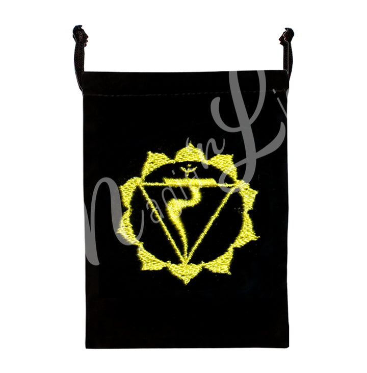 A black bag featuring an embroidered solar plexus chakra yellow design