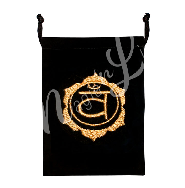 A black bag featuring an embroidered sacral chakra orange design