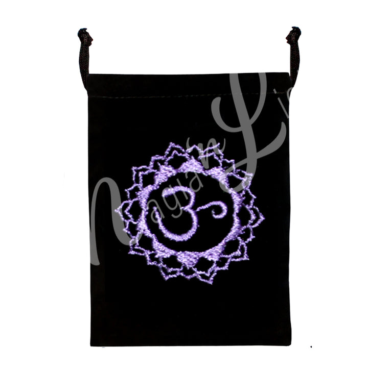A black bag featuring an embroidered crown chakra purple design