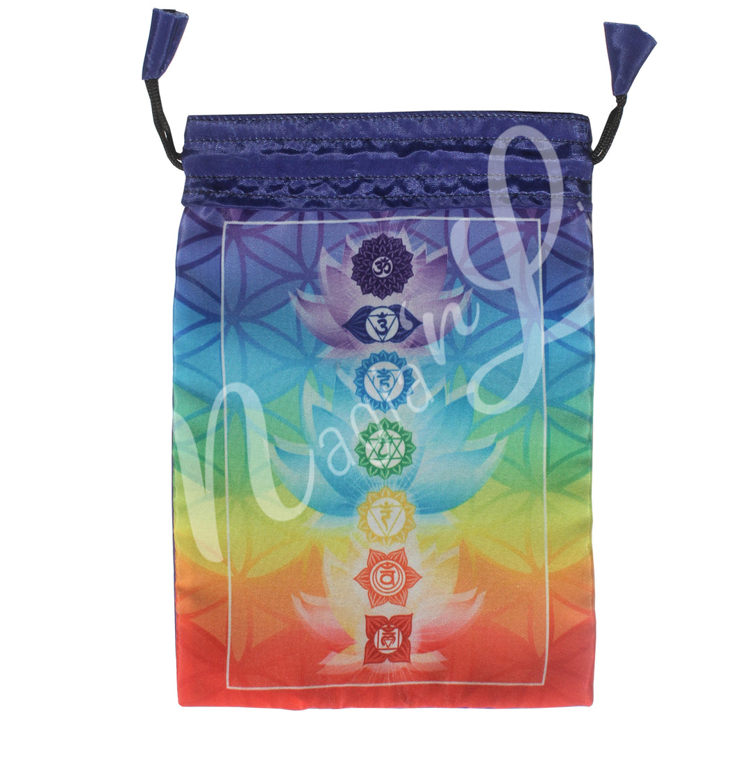 A purple drawstring pouch with a mystical design featuring the seven chakra symbols with their respective color, surrounded by decorative flower of life motifs.