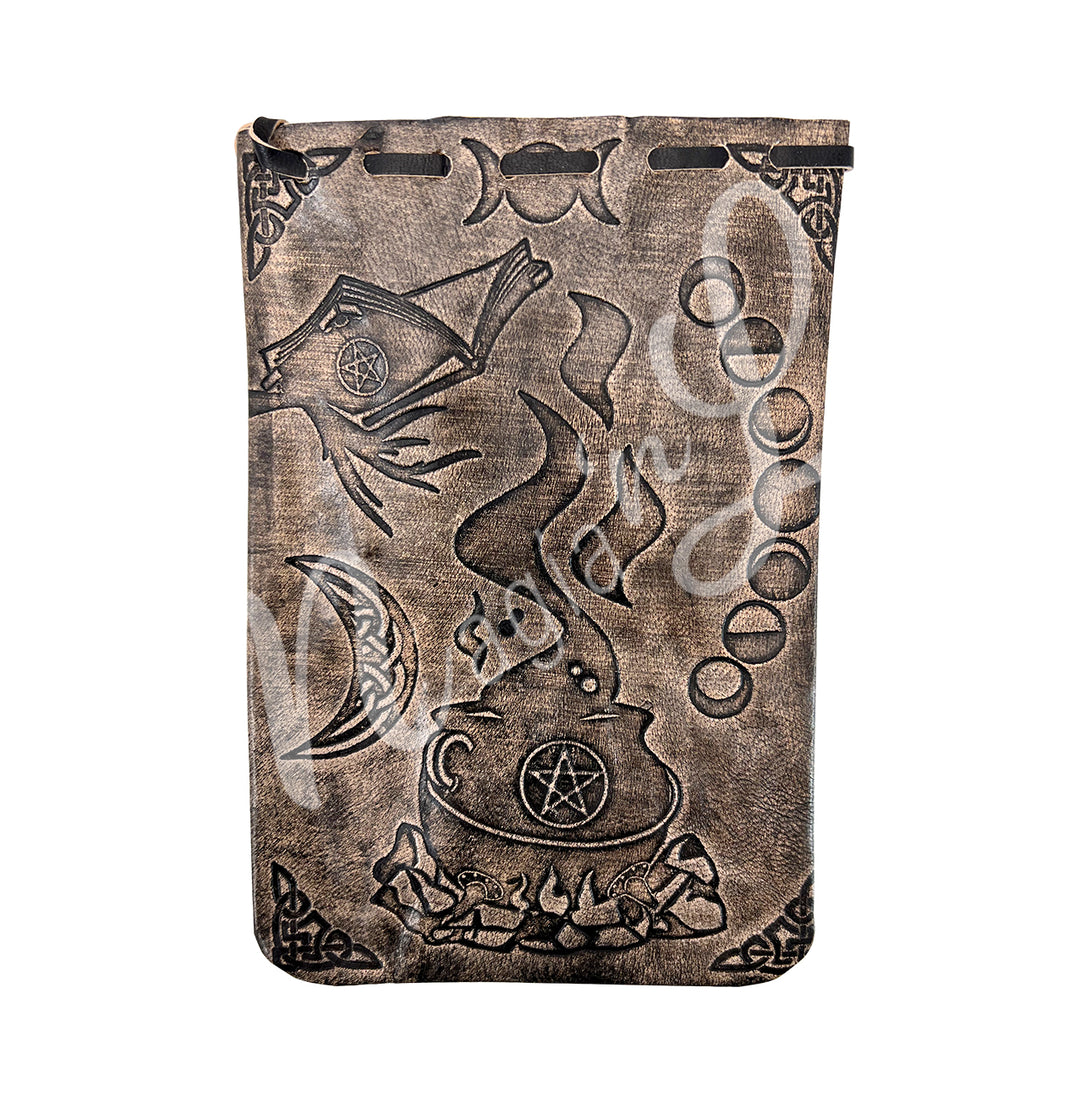 A brown bag made of leather, featuring a cauldron, moon phase and a celtic moon design.
