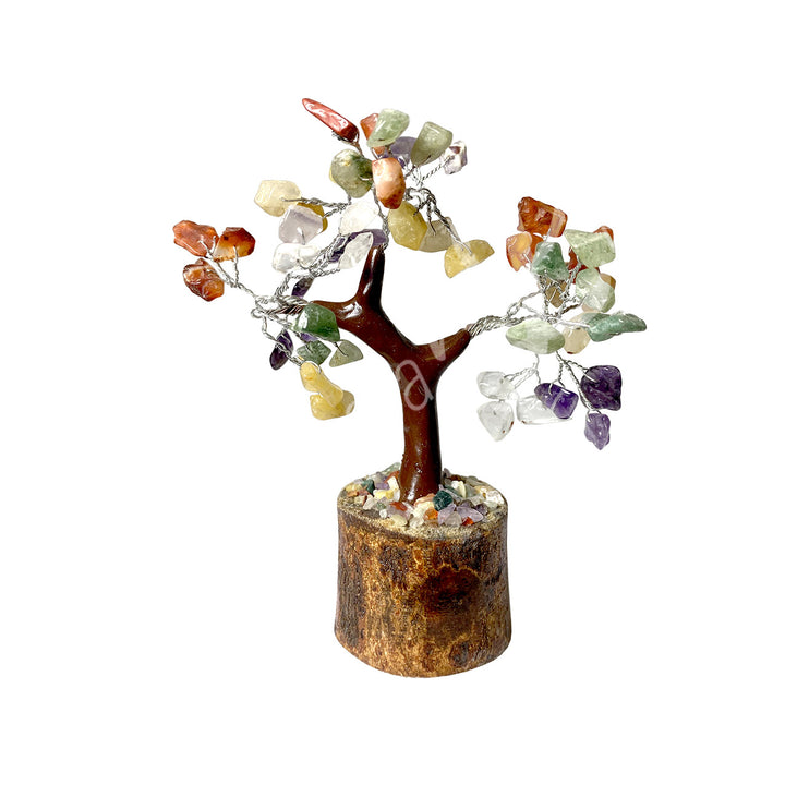 A wire gemstone bonsai tree with mixed stone chips, mounted on a natural base.