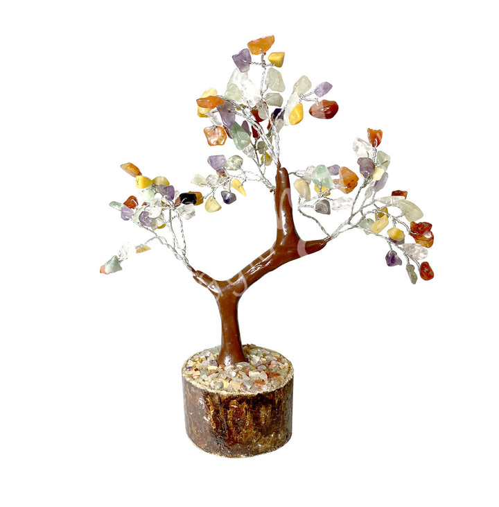 A wire gemstone bonsai tree with mixed stone chips, mounted on a natural base.