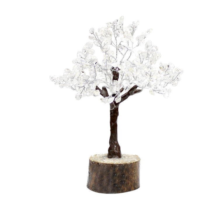 A wire gemstone bonsai tree with crystal quartz chips, mounted on a natural base.