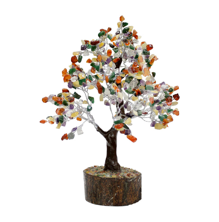 A wire gemstone bonsai tree with mixed stone chips, mounted on a natural base.