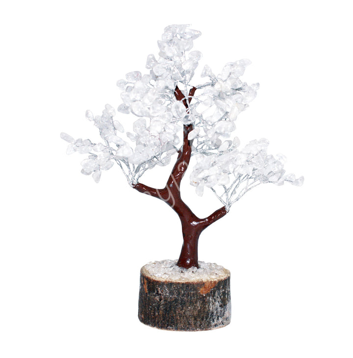 A wire gemstone bonsai tree with crystal quartz chips, mounted on a natural base.