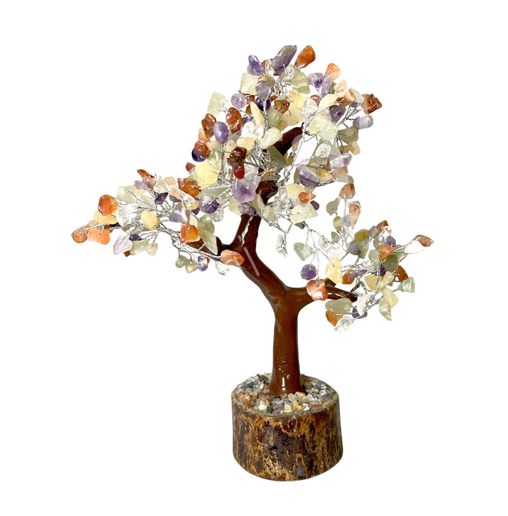 A wire gemstone bonsai tree with mixed stone chips, mounted on a natural base.