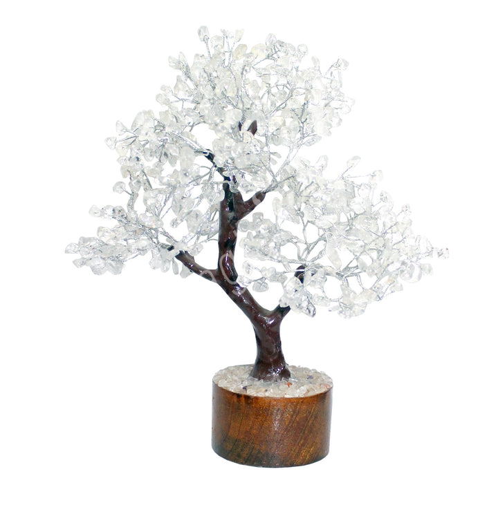 A wire gemstone bonsai tree with crystal quartz chips, mounted on a natural base.