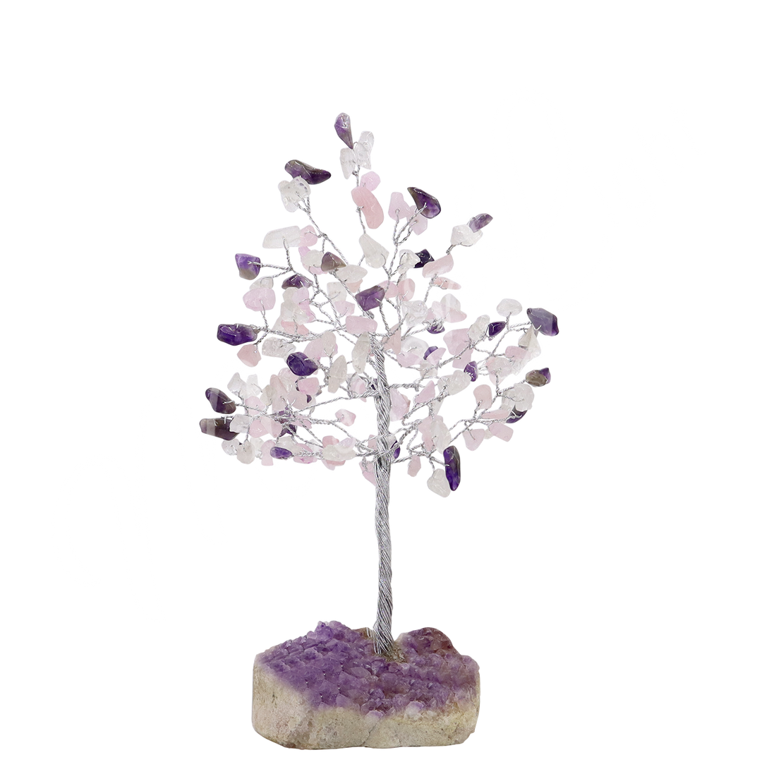 A wire gemstone bonsai tree with amethyst chips, mounted on a natural geode base.